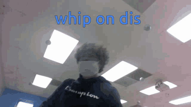a person wearing a mask and a champion sweatshirt