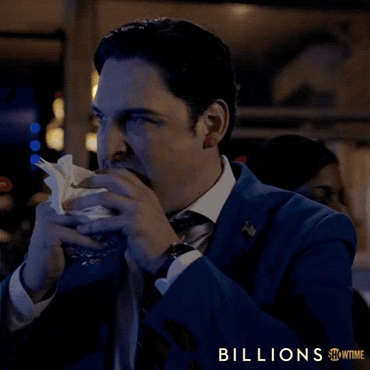 a man in a suit and tie with the word billions on the bottom right