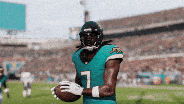 a football player wearing a number 7 jersey holds a football