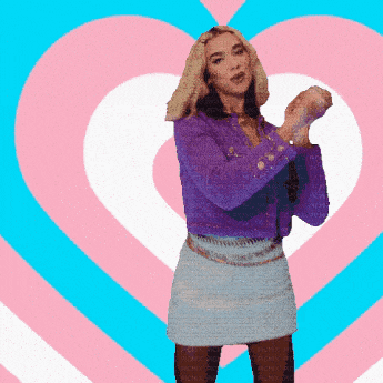 a woman in a purple jacket is dancing in front of a pink heart