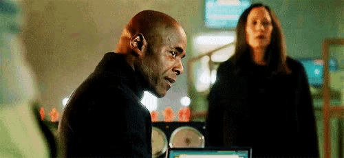 a man and a woman are standing next to each other in a room .