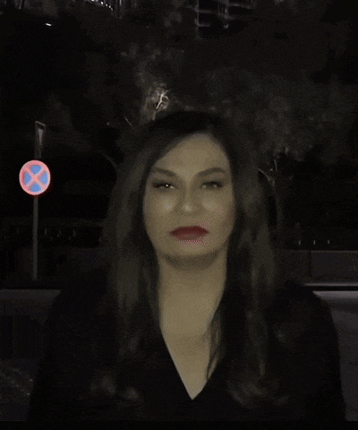 a woman is standing in front of a do not enter sign