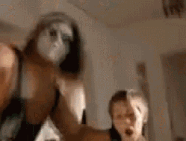 a blurry picture of a man and a woman in a room .
