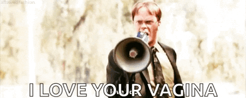 a man in a suit and tie is holding a megaphone in his mouth and shouting into it .