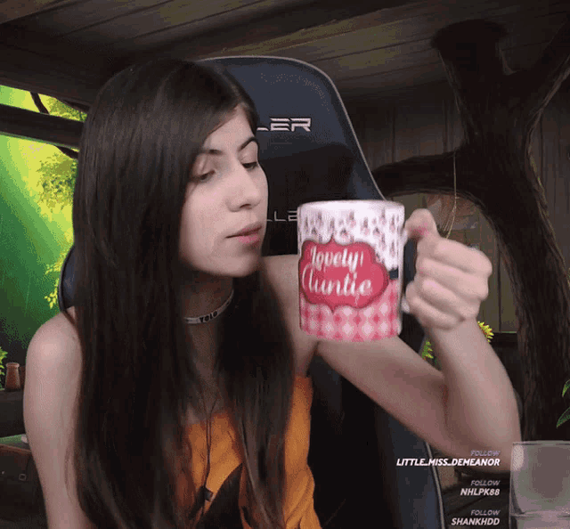 a woman holding a mug that says " lovely charlie "