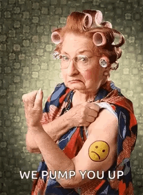 an elderly woman with curlers in her hair has a sad face tattoo on her arm .