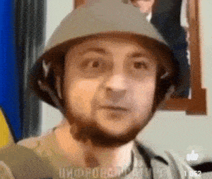 a man with a beard is wearing a military helmet and looking at the camera .