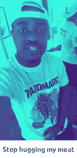 a man wearing a t-shirt that says raidmarc takes a selfie