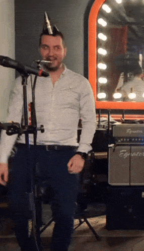 a man is singing into a microphone in front of an equalizer amplifier