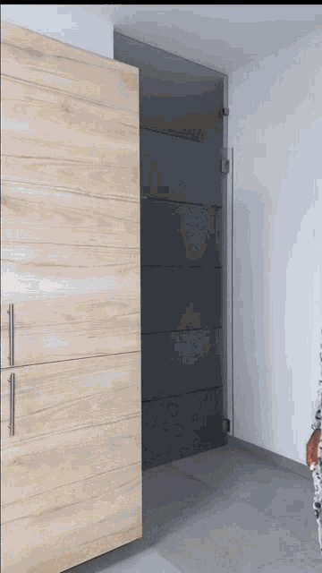 a sliding glass door with a wooden cabinet behind it