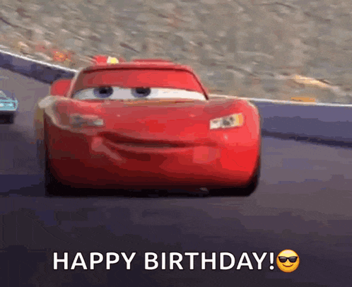 a red car from the movie cars is driving down a race track and says happy birthday .