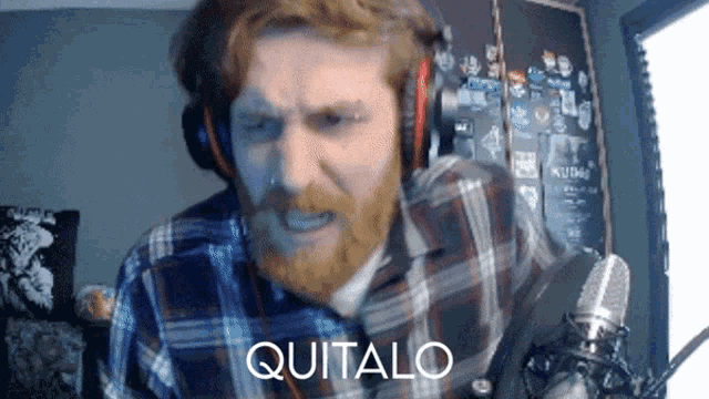 a man with a beard wearing headphones and a plaid shirt says quitalo