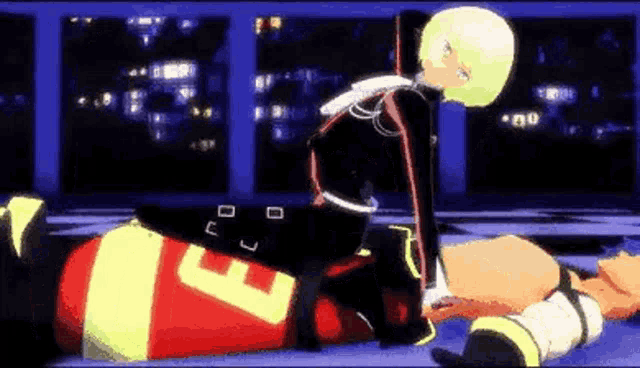 a girl is sitting on top of a man in a wrestling ring .