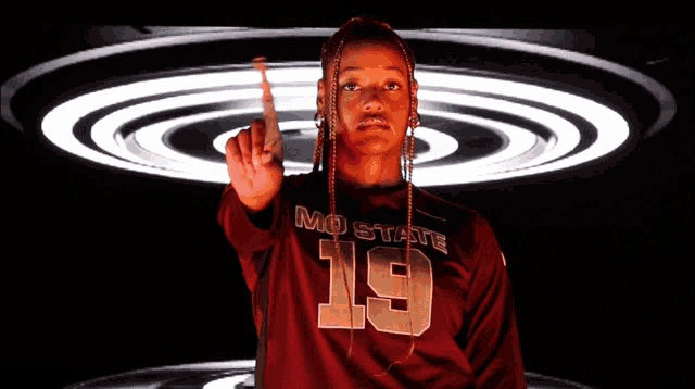 a woman wearing a mo state jersey with the number 19