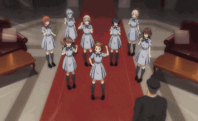 a group of girls are standing on a red carpet