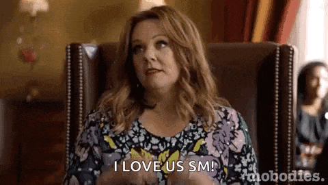 a woman is sitting in a chair and saying `` i love us sm ! ''