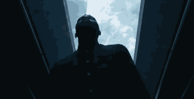 a man in a black shirt is looking up into the sky