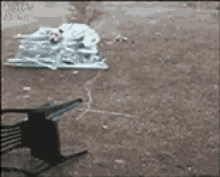 a rocking chair is laying on the ground next to a pile of trash