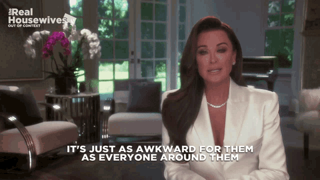 a woman in a white suit is talking about real housewives