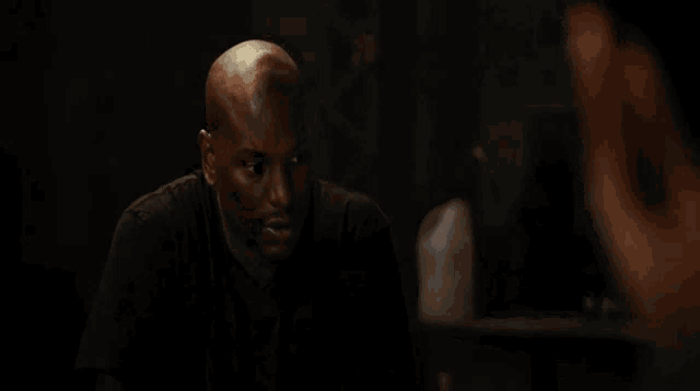 a man and a woman sit next to each other in a dark room