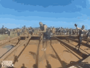 a person 's feet are covered in mud and the words jukin video are on the bottom