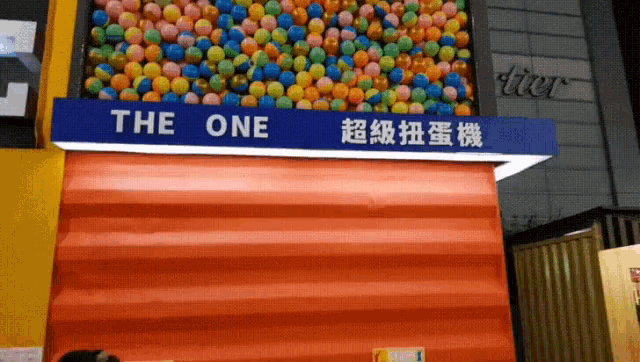 a blue sign that says the one is above an orange building
