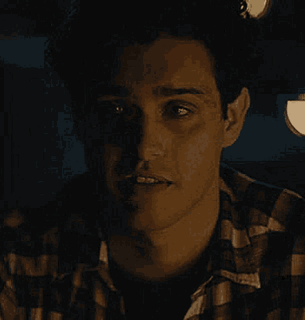 a man in a plaid shirt has a black eye