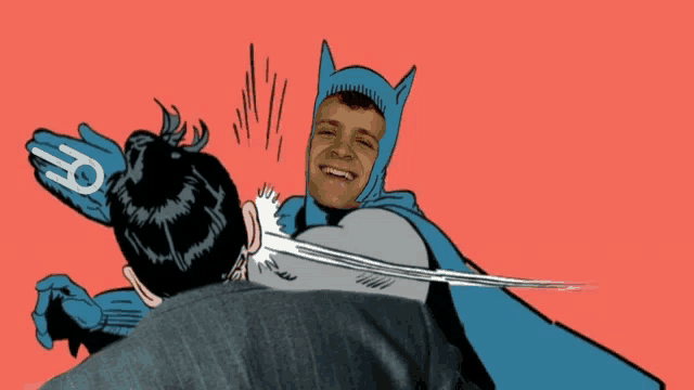 a man in a batman costume is being punched by another man