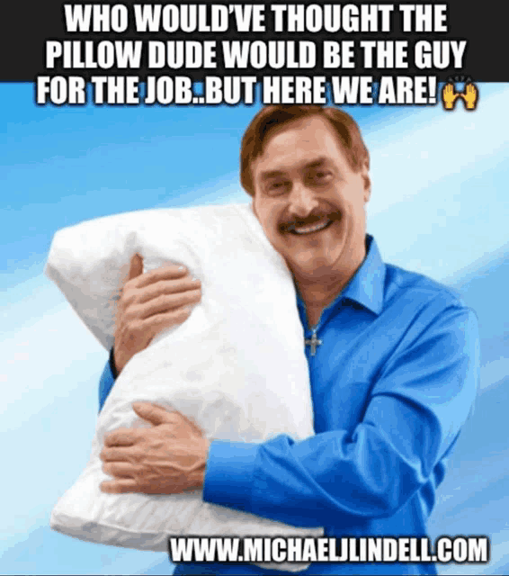 a man in a blue shirt is hugging a white pillow with the website www.michaellindell.com at the bottom of the picture