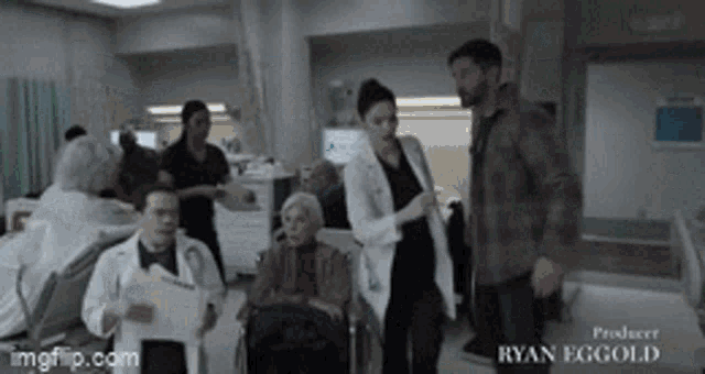 a group of people standing in a hospital room with ryan eggold written on the bottom