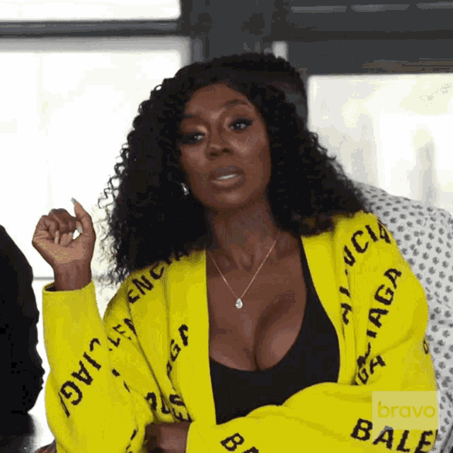 a woman wearing a yellow balenciaga cardigan