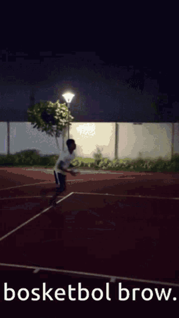 a man playing basketball on a court with the words bosketbol brow