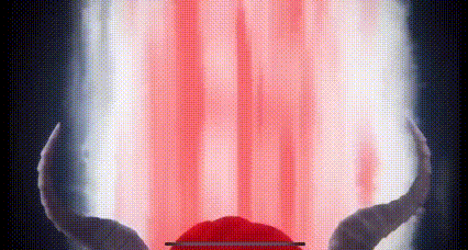 a person with horns is standing in front of a red light coming from behind them .