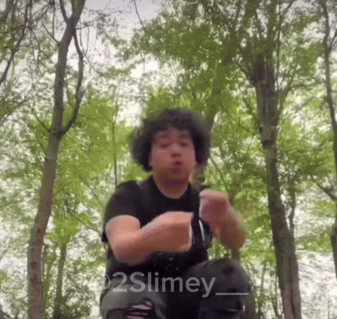 a man in a black shirt is dancing in the woods with the words 2slimey written on the bottom