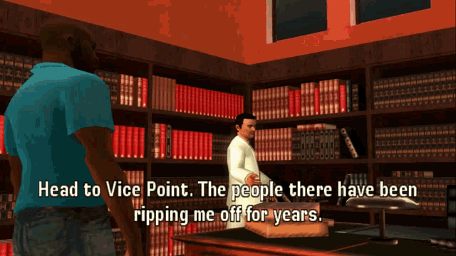a man in a blue shirt is talking to a man in a white shirt in a library