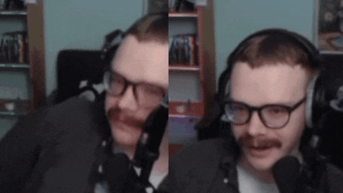 a man wearing glasses and headphones is talking into a microphone