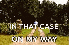 a man is walking down a dirt road in a field .