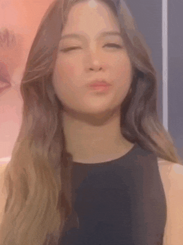a close up of a woman making a funny face .