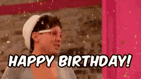 a man wearing glasses and a hat is saying `` happy birthday '' .