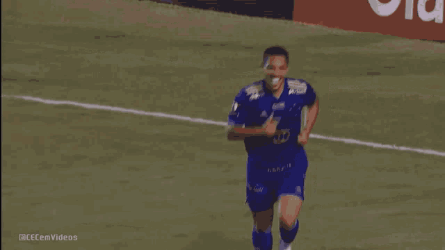 a man in a blue jersey with the number 3 on it is running on a soccer field