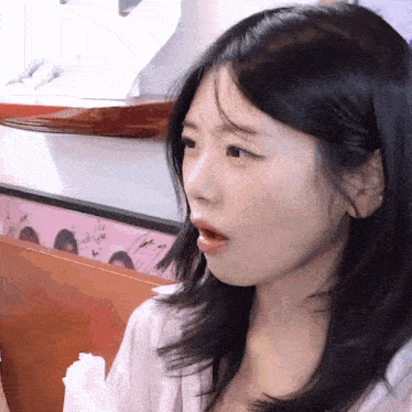 a close up of a woman with a surprised look on her face