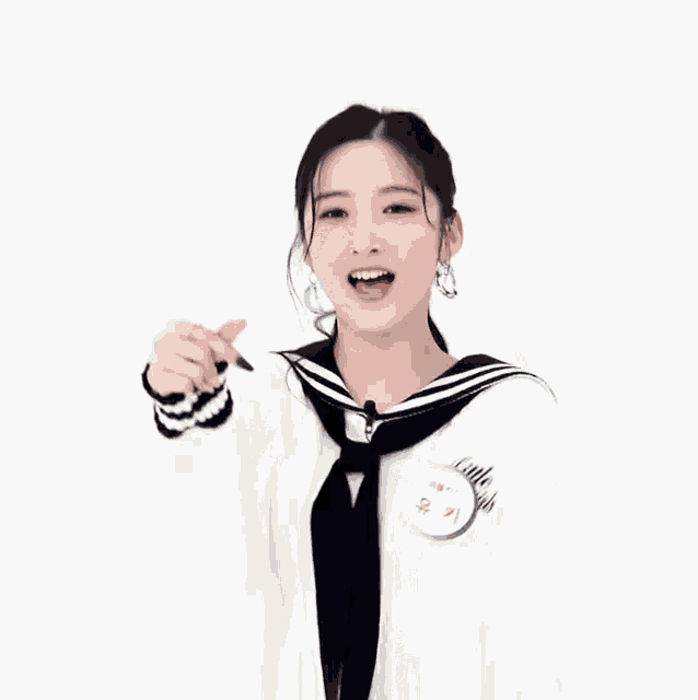 a girl with a name tag that says ' yun ' on it giving a thumbs up