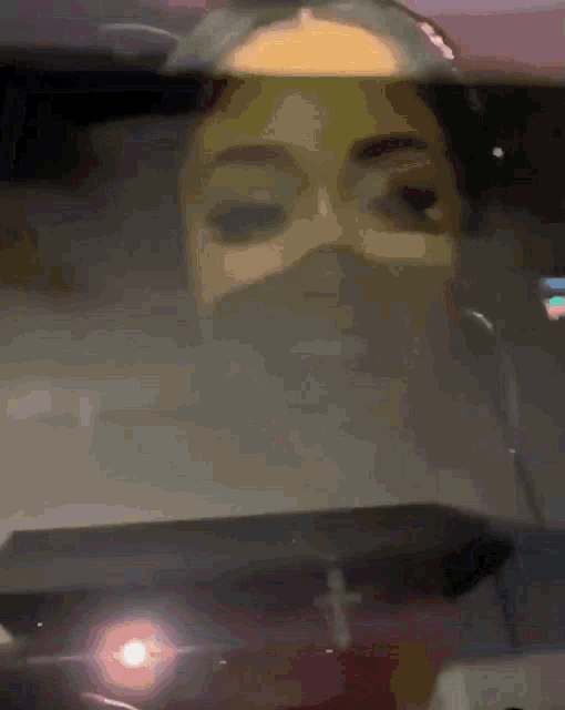 a close up of a woman 's face through a car windshield