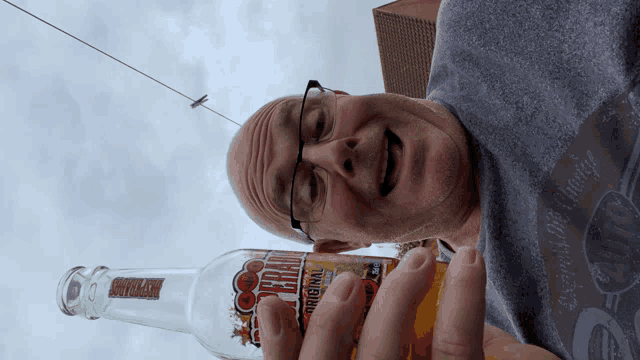 a man is holding a bottle of beer that says " original " on it