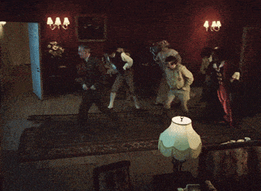 a group of people are standing in a room with red walls