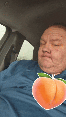 a man in a blue shirt with a peach on his shirt