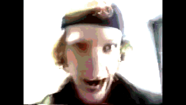 a blurry picture of a man wearing a beret with the letter j on it
