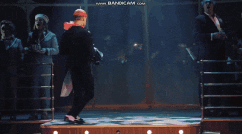 a man in a red hat is dancing on a stage with the words www.bandicam.com in the upper right corner