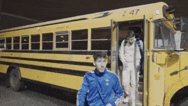 the number 247 is on the side of a yellow bus