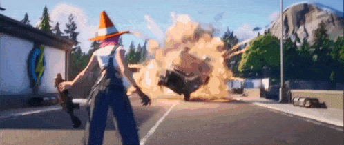 a woman in a cone hat is standing in front of a car that is exploding in a video game .